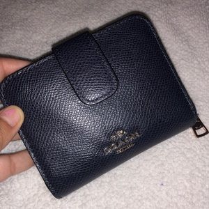 Pre own Coach wallet color is navy blue
